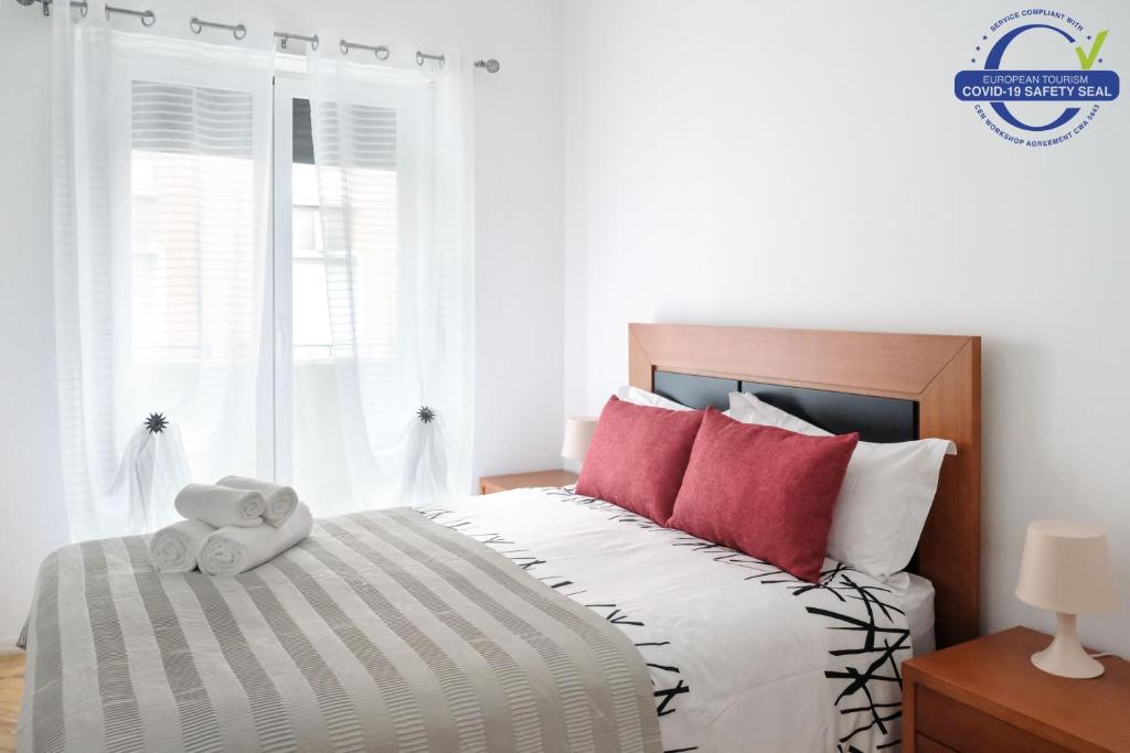 a bedroom with a bed with a teddy bear on it at 92 Campolide Apartment by Trip2Portugal in Lisbon