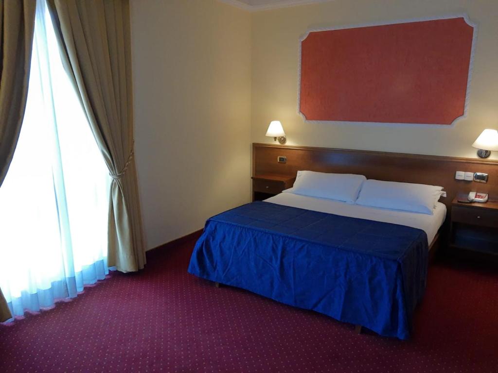 Postel nebo postele na pokoji v ubytování Hotel Antiche Terme Benevento