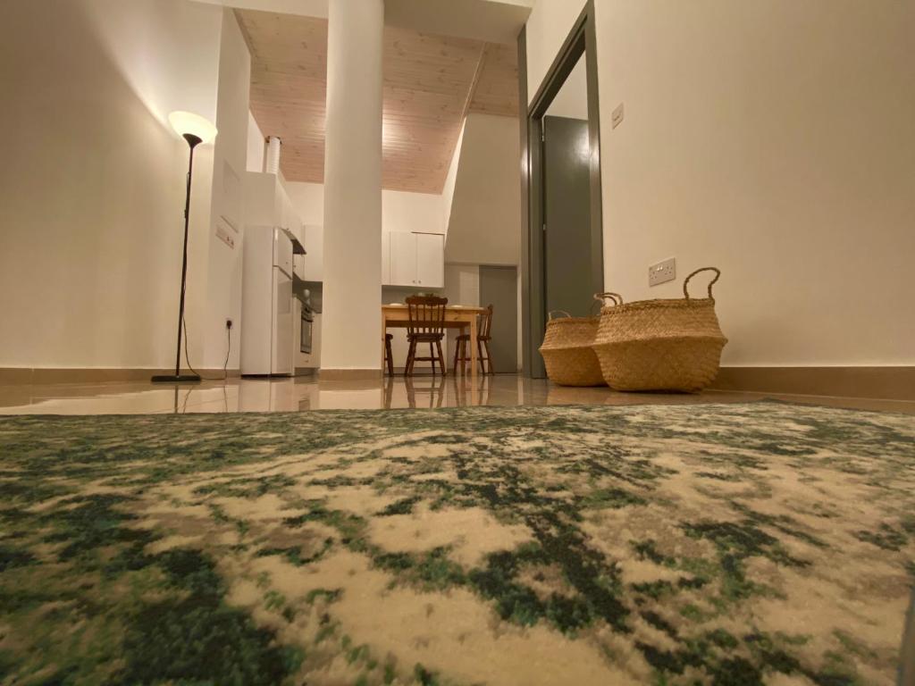 a room with a table and a rug on the floor at Central Suites Perikleous 53 Down Town Nicosia By Platform 357 in Nicosia