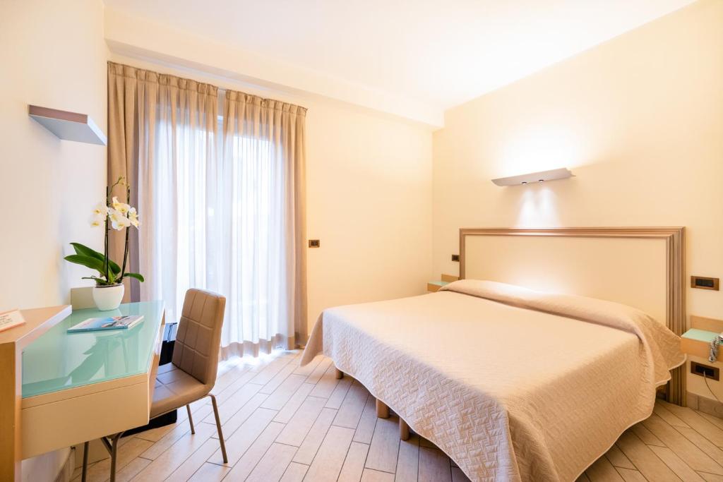 Postel nebo postele na pokoji v ubytování Hotel Il Gabbiano