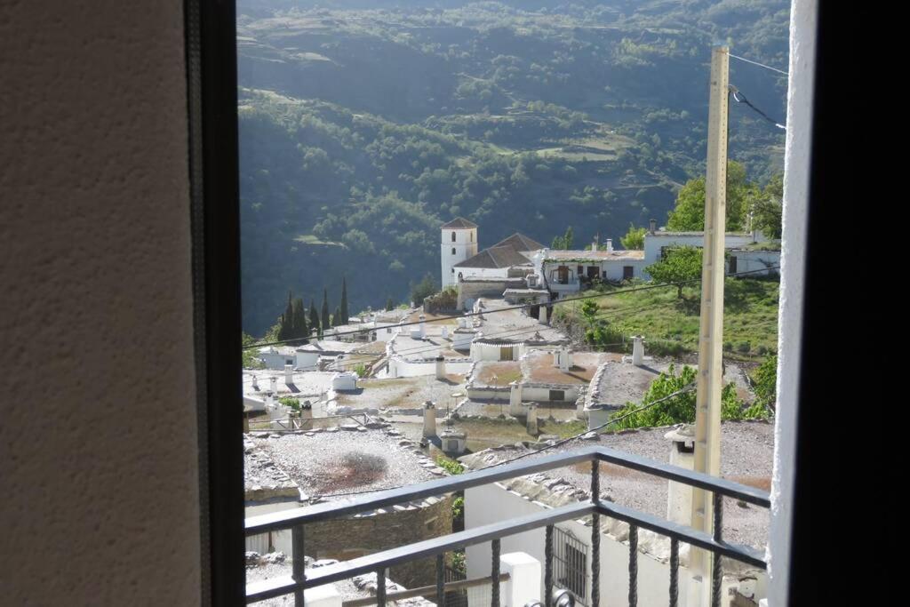 a view of a village from a window at Casa La Soleá. Vistas al pueblo y la Sierra in Bubión