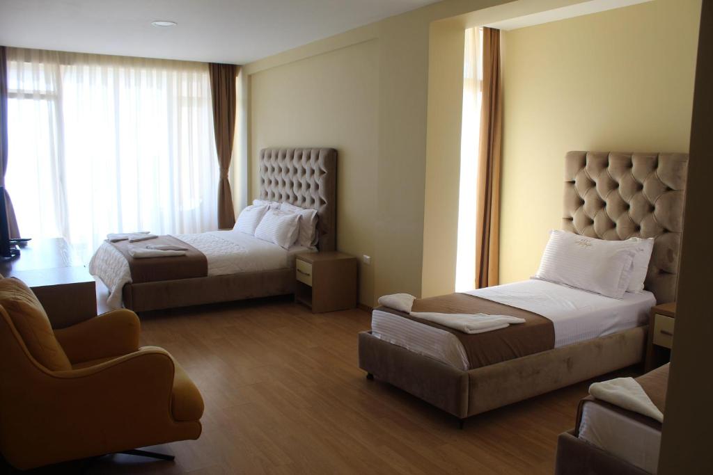 Postel nebo postele na pokoji v ubytování Hotel Frojd - Beach Front Resort