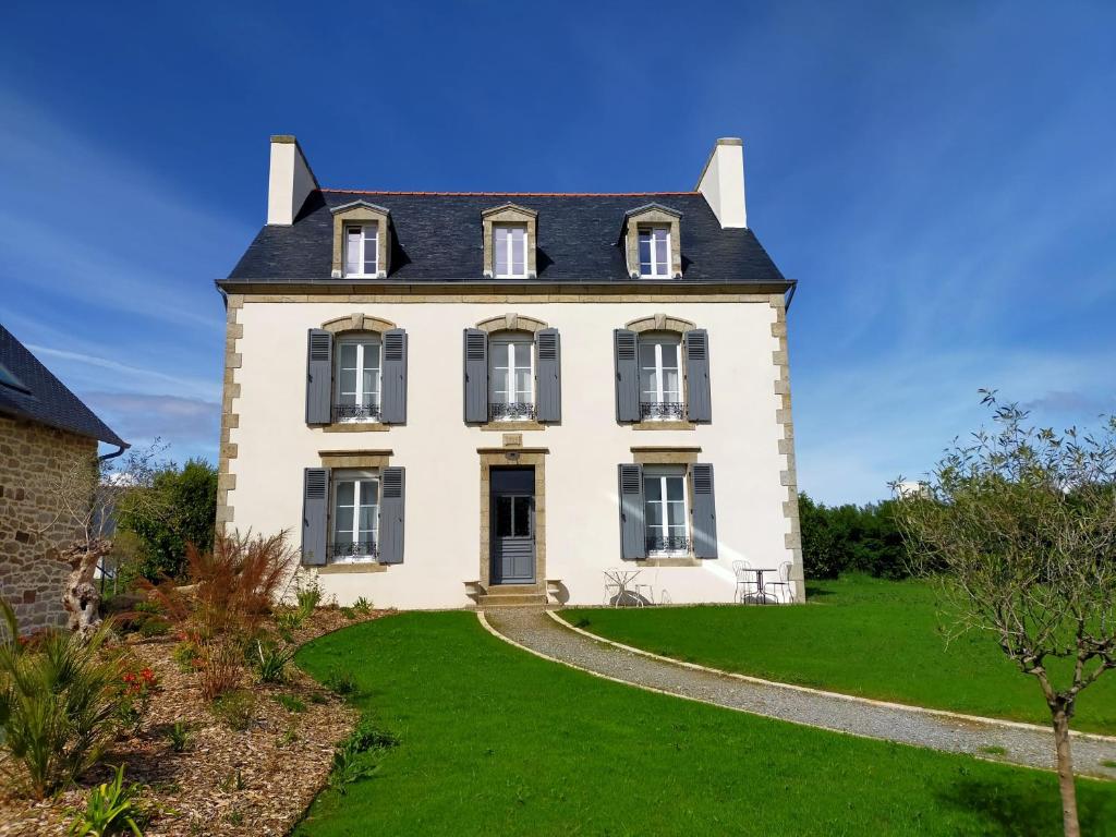 a large white house with a black roof at La Belle Epoque in Kerlaz