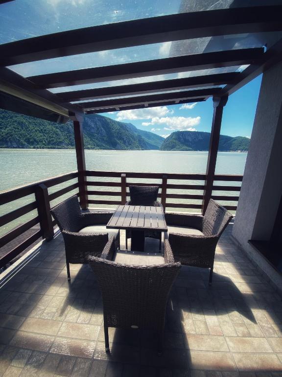 a table and chairs on the deck of a boat at Casa Maria Dubova in Dubova