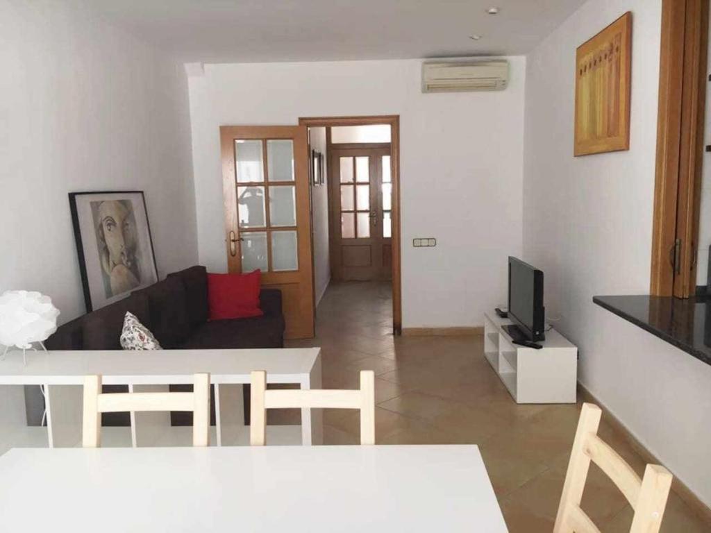 a living room with a couch and a tv at Nice and quiet flat in Premià de Mar HUTB in Premiá de Mar