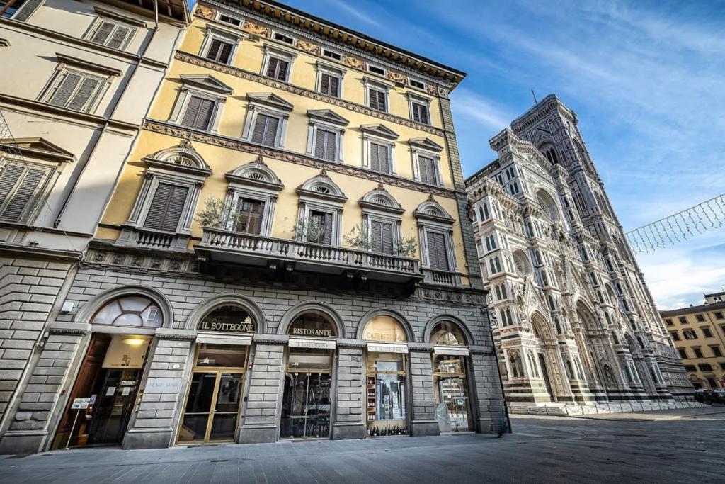 a large building with a clock on the front of it at Palazzo Gamba Apartments al Duomo in Florence