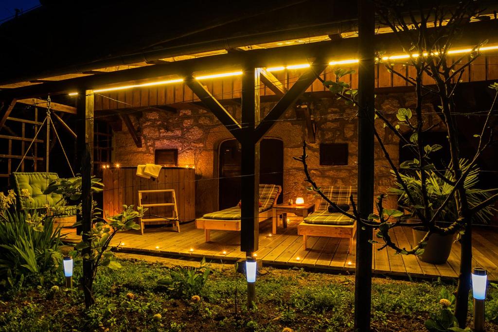 a patio lit up at night with lights at Zidanica Lackner in Črnomelj