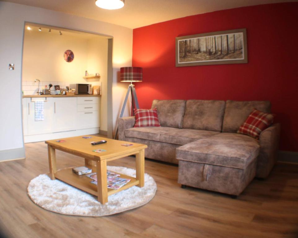 a living room with a couch and a coffee table at Immaculate 1 Bed Apartment in Pitlochry Scotland in Pitlochry