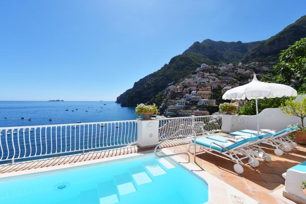 a swimming pool with a view of the ocean at Villa Boheme Exclusive Luxury Suites in Positano