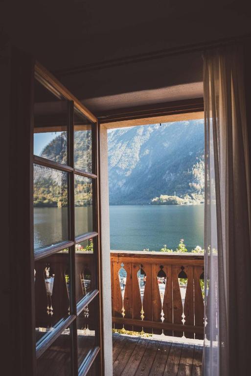 a room with a view of a lake from a window at Heritage Hotel Hallstatt in Hallstatt