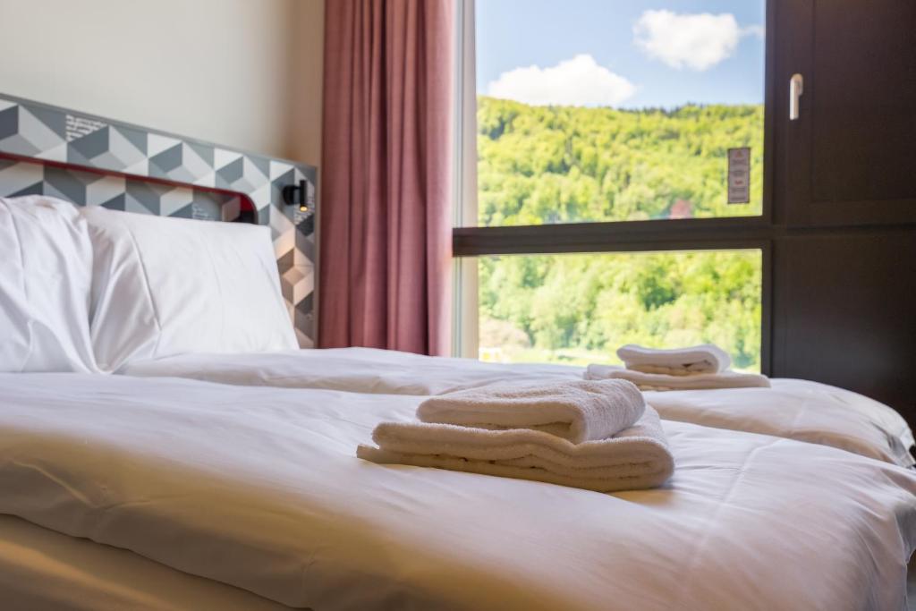 Letto o letti in una camera di MEININGER Hotel Zürich Greencity