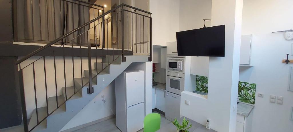 a living room with a staircase with a flat screen tv at valencialoft in Valencia