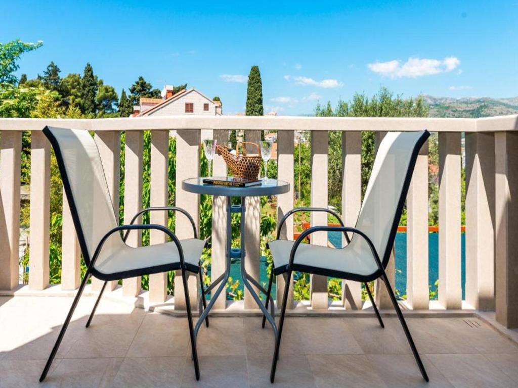 two chairs and a table on a balcony at Apartments & Rooms V&M in Dubrovnik