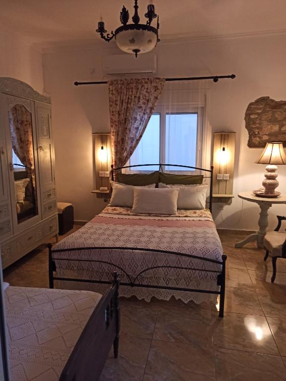 a bedroom with a large bed and a window at KD Vintage Home in Lavrio