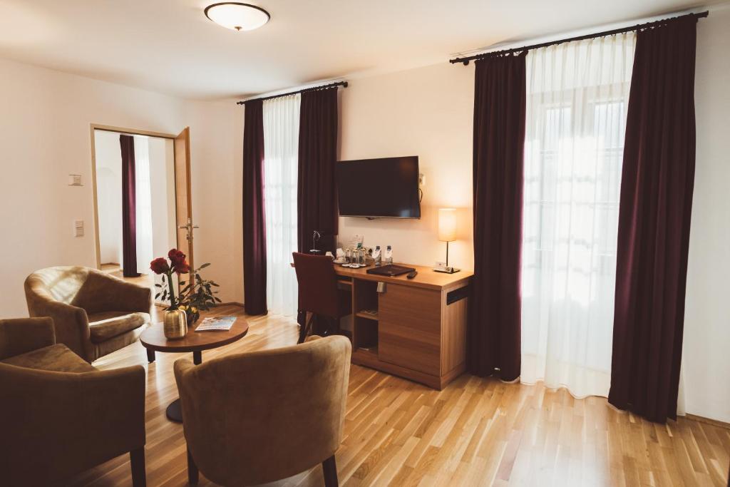 a hotel room with a desk and a room at Heritage Hotel Hallstatt in Hallstatt