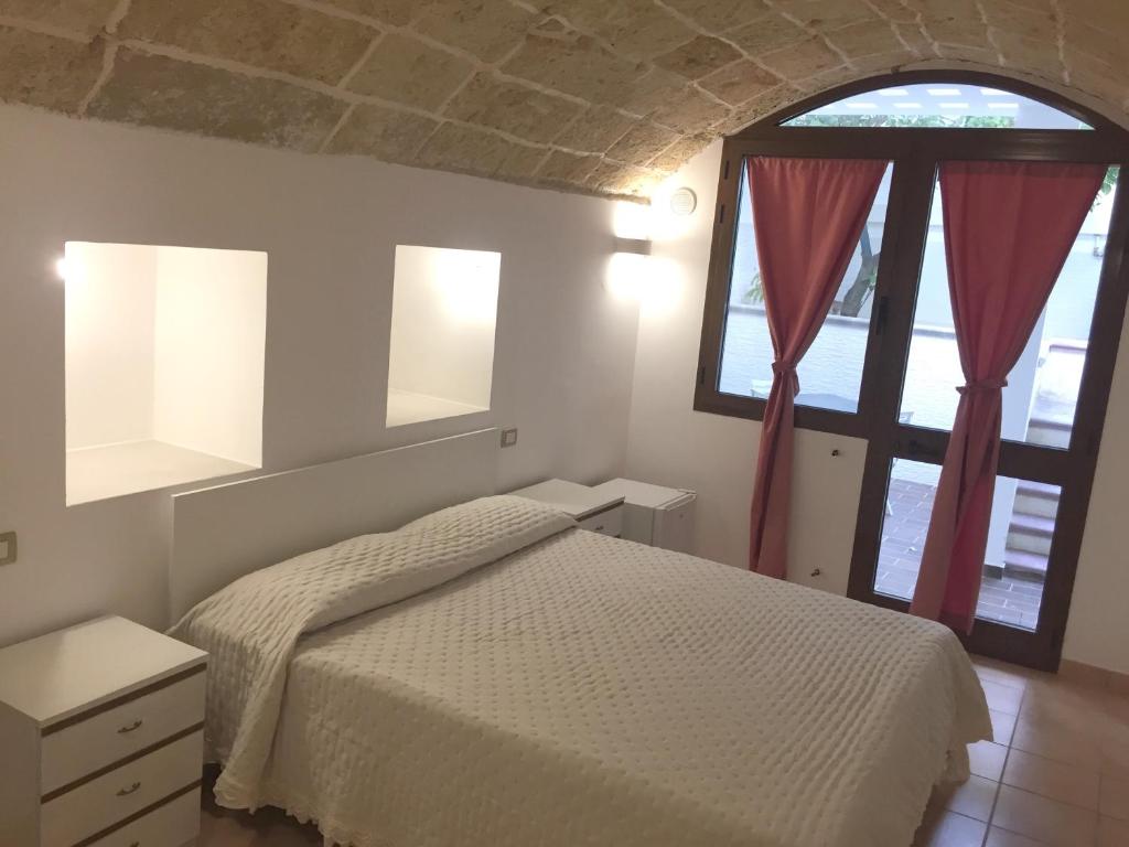 A bed or beds in a room at Ugento Dimora