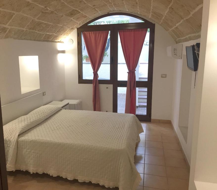 A bed or beds in a room at Ugento Dimora