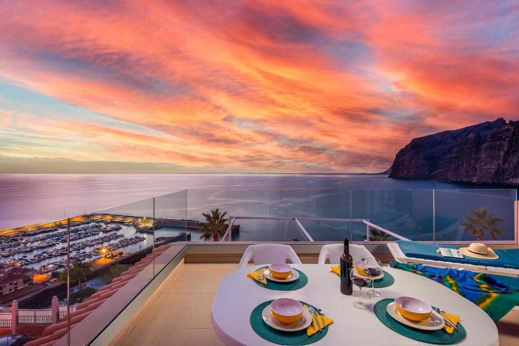 a table on a cruise ship with a sunset at Los Gigantes Paradise in Acantilado de los Gigantes