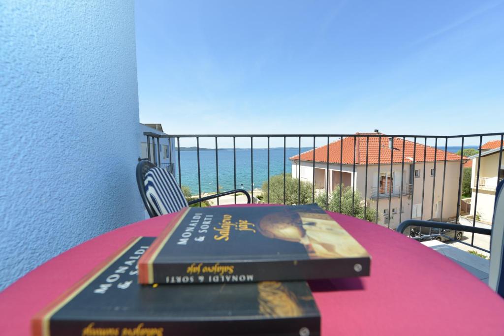 dos libros sentados sobre una mesa en un balcón en Apartment Nadica, en Kožino