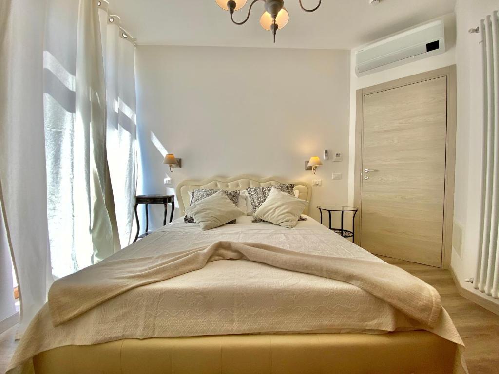 a bedroom with a large bed with a large window at UNIQUE ROOMS in Verona