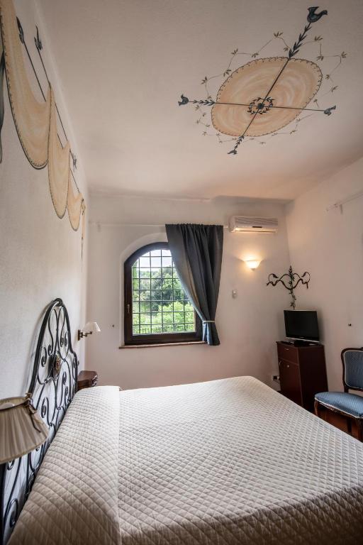 Postel nebo postele na pokoji v ubytování Hotel Vecchia Oliviera