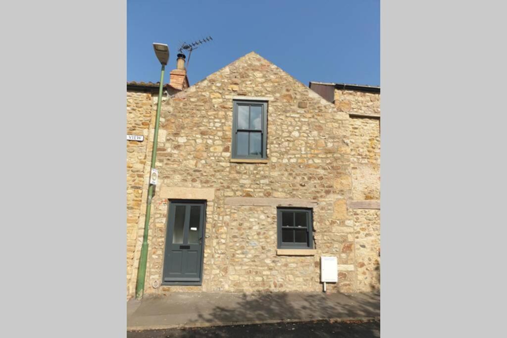 a stone house with a window on the side of it at Cosy Cottage in Gainford