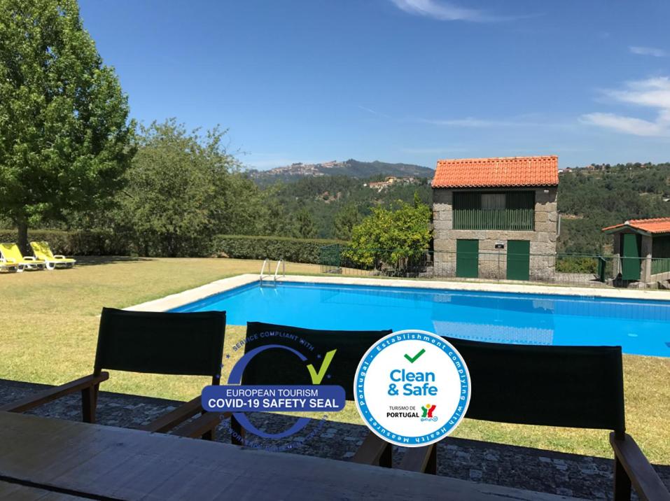 a sign sitting next to a swimming pool at Quinta do Ladário in Várzea Ovelha e Aliviada