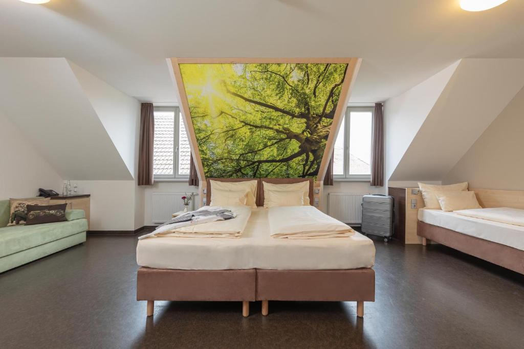 a bedroom with a bed with a painting on the wall at Radlhotel Wassertrüdingen in Wassertrüdingen