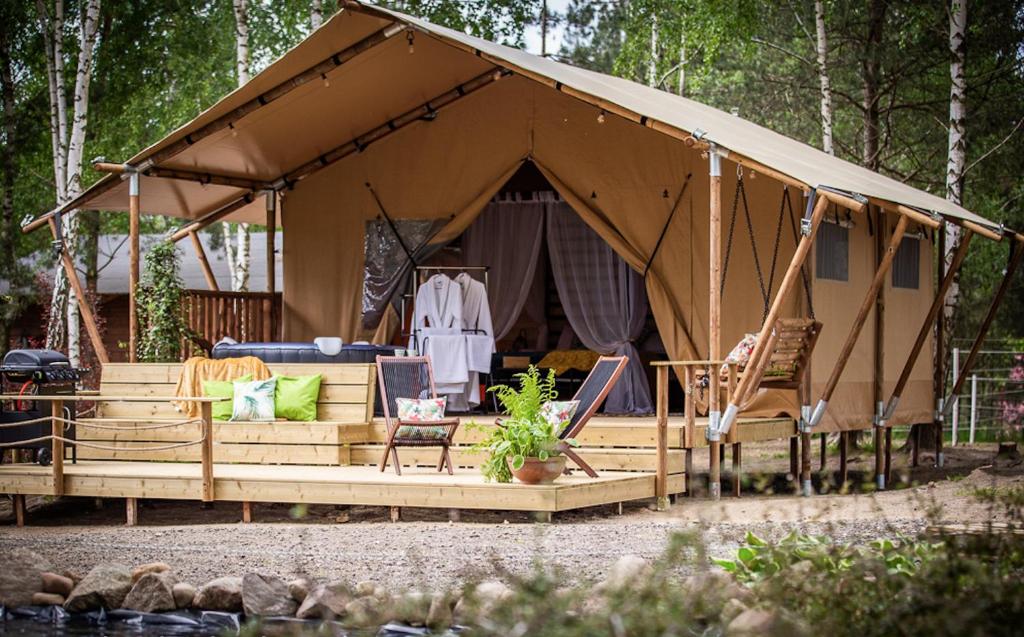 a tent with a table and chairs in it at Kaskada Glamping in Łódź