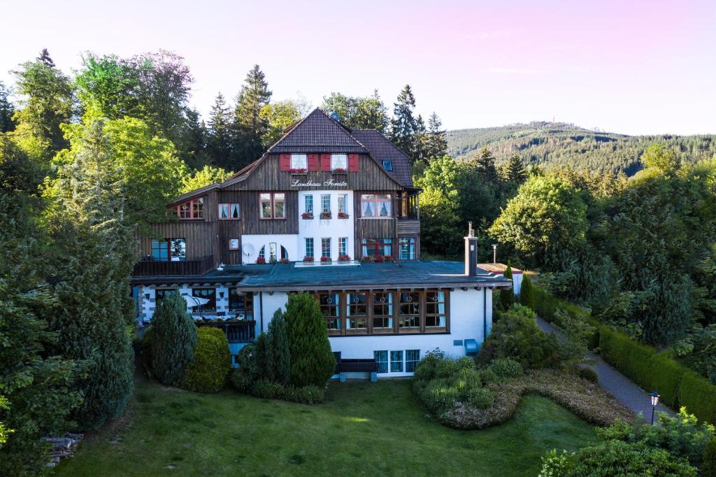an aerial view of a large house in the forest at Landhotel Villa Foresta in Braunlage