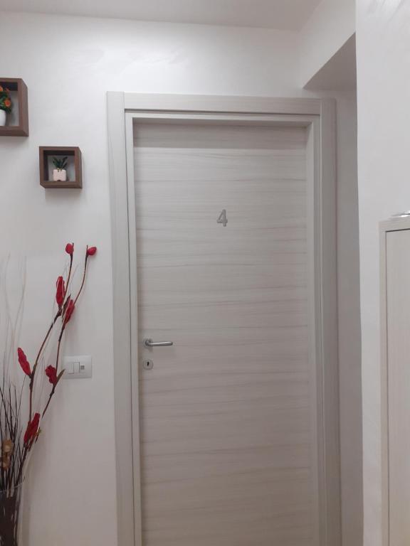 a white door with a butterfly on it in a room at Maison Marguerite in Margherita di Savoia