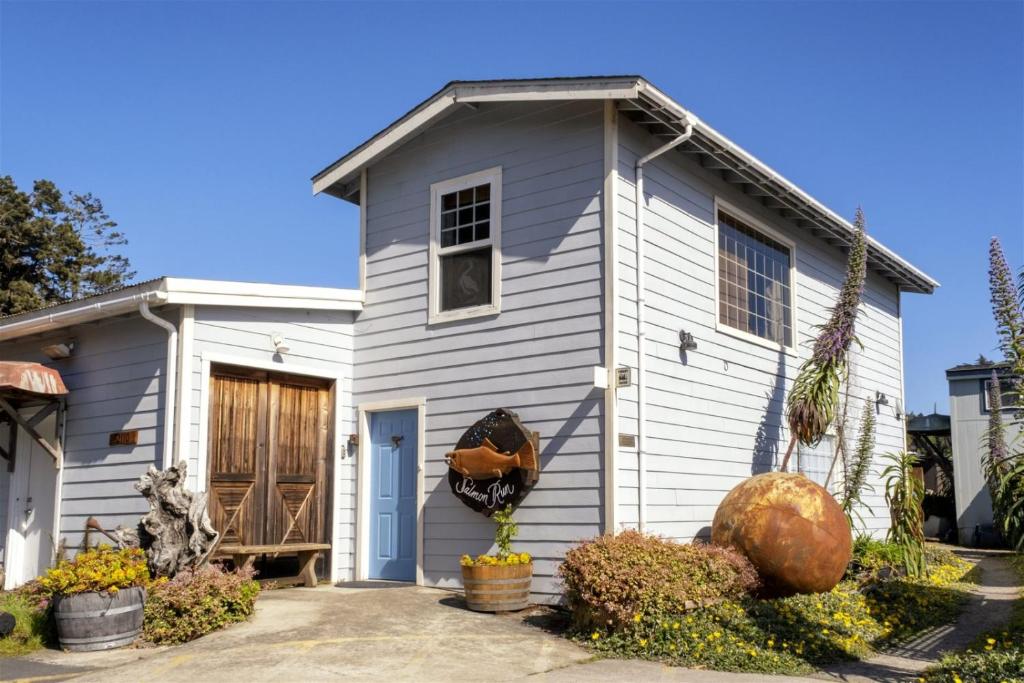 a small white house with a porch at H - Salmon Run in Fort Bragg