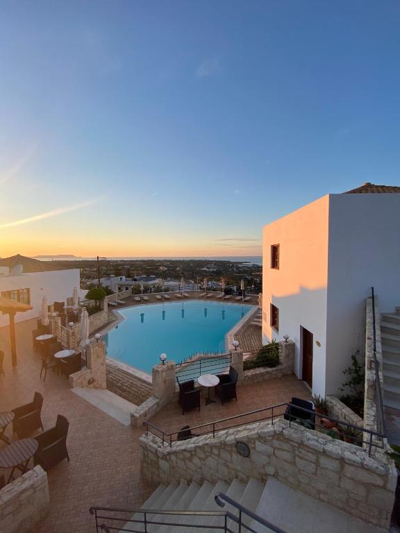 a view of a swimming pool on a building at Amazones Village Suites in Hersonissos
