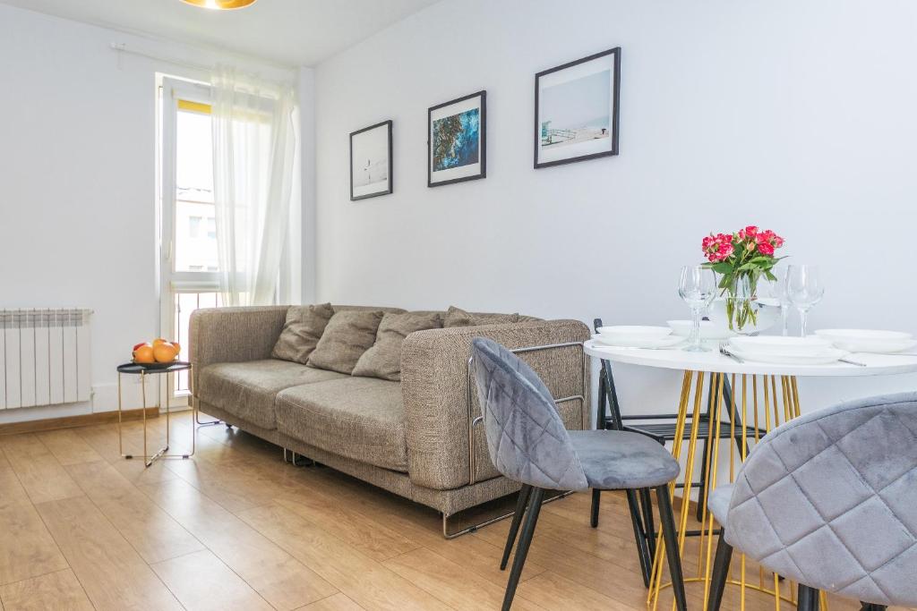 a living room with a couch and a table at Hello Apartments Dworska LIGHT in Gdańsk