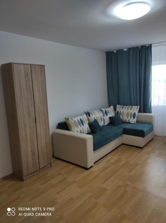 a living room with a couch and a cabinet at Dayly House Apartament Sulina in Sulina