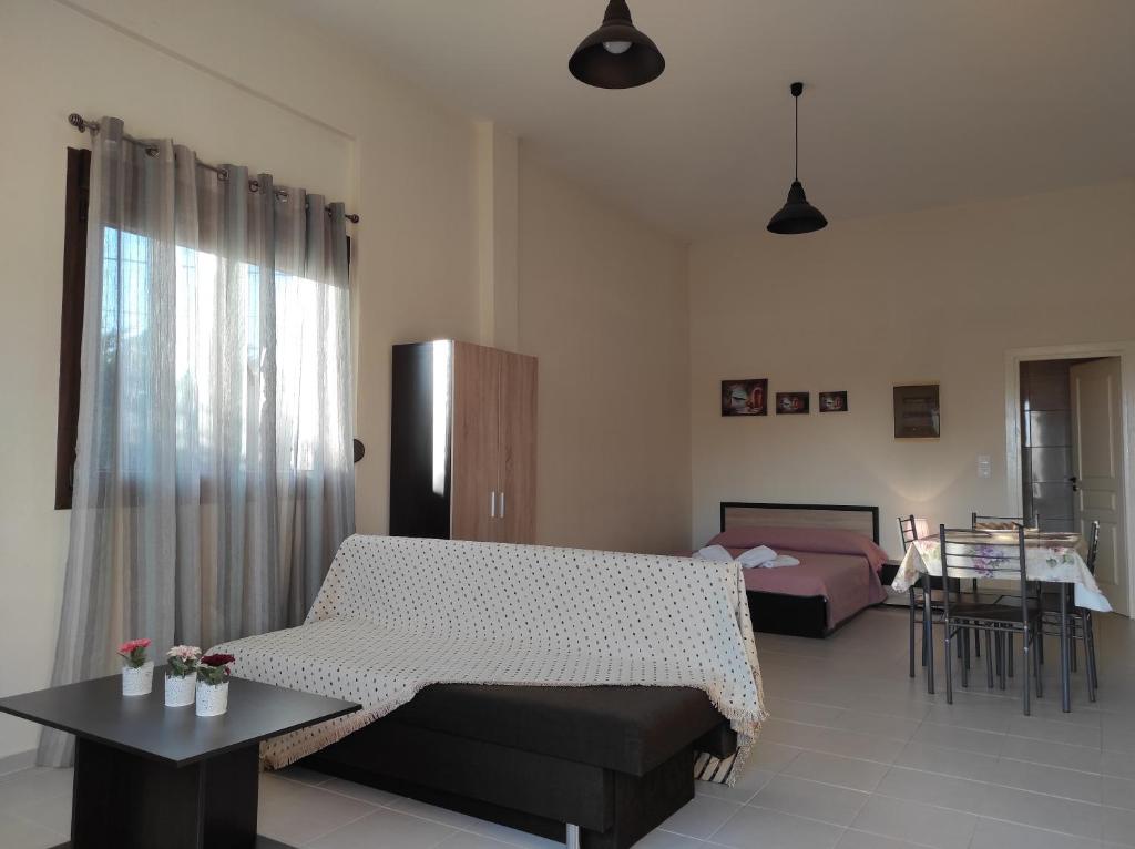 a living room with a couch and a table at John's Apartments in Nea Michaniona