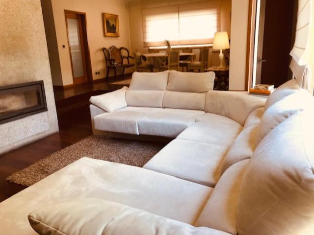 a living room with white couches and a fireplace at Bracara luxury guesthouse in Braga