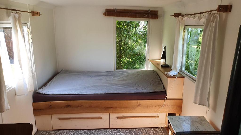 Postel nebo postele na pokoji v ubytování Ferienwohnung mit Tiny House