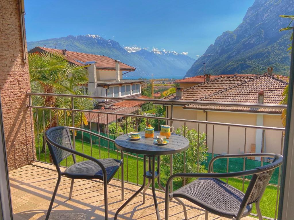 Una mesa y sillas en un balcón con vista. en Villa Desy, en Riva del Garda