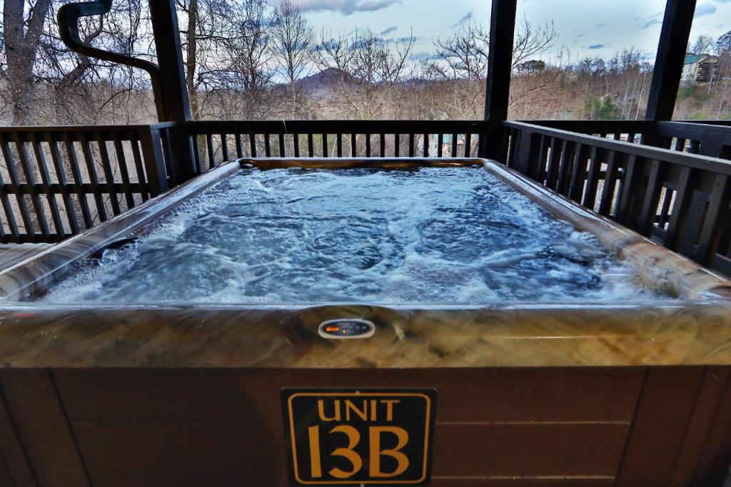 a hot tub with water in it on a deck at Briarstone Lodge Condo 13B in Pigeon Forge