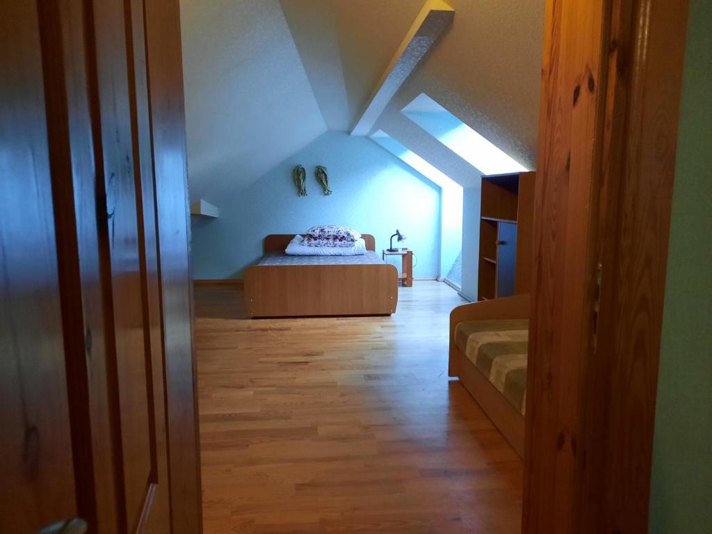 a bedroom with a bed in a attic at Patalpos Netoli Juros in Šventoji