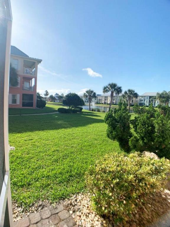 a yard with a house and a large lawn at Seaside at Anastasia C101 in St. Augustine