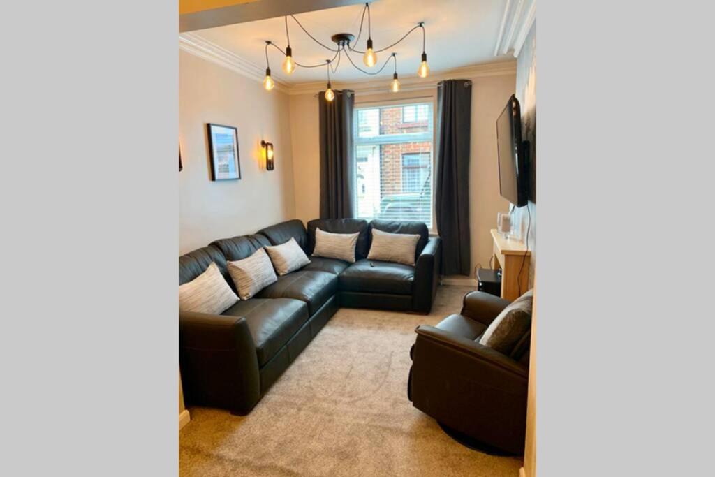 uma sala de estar com um sofá e uma televisão em Durham House - Fantastic Location and Great Price in Scarborough em Scarborough