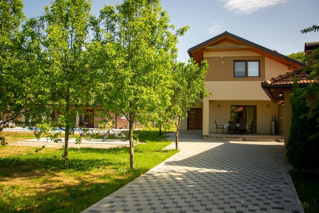 a walkway in front of a house with trees at Oasis of peace in Bihać