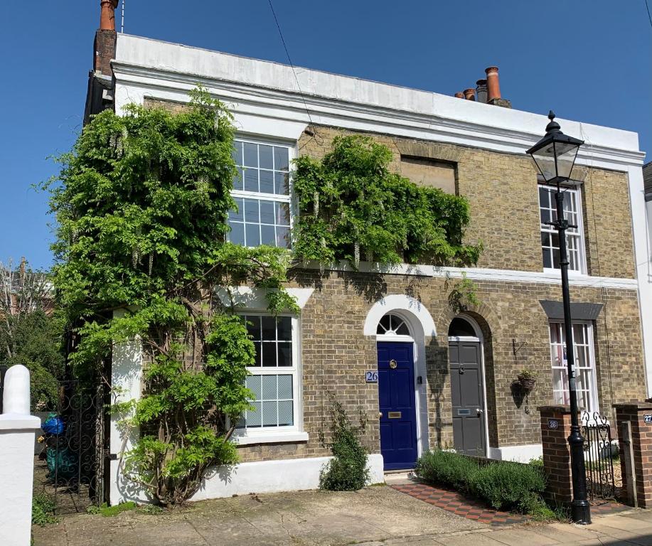 a brick house with a blue door at Esme's in Winchester