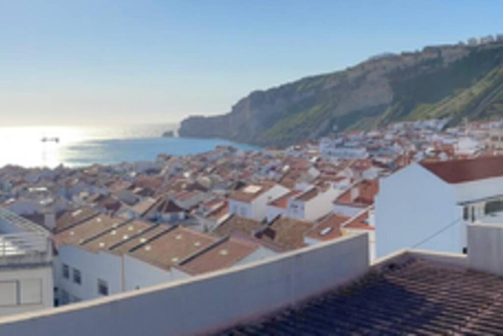 a view of a city with the ocean and buildings at The Light House II, with rooftop and parking in Nazaré