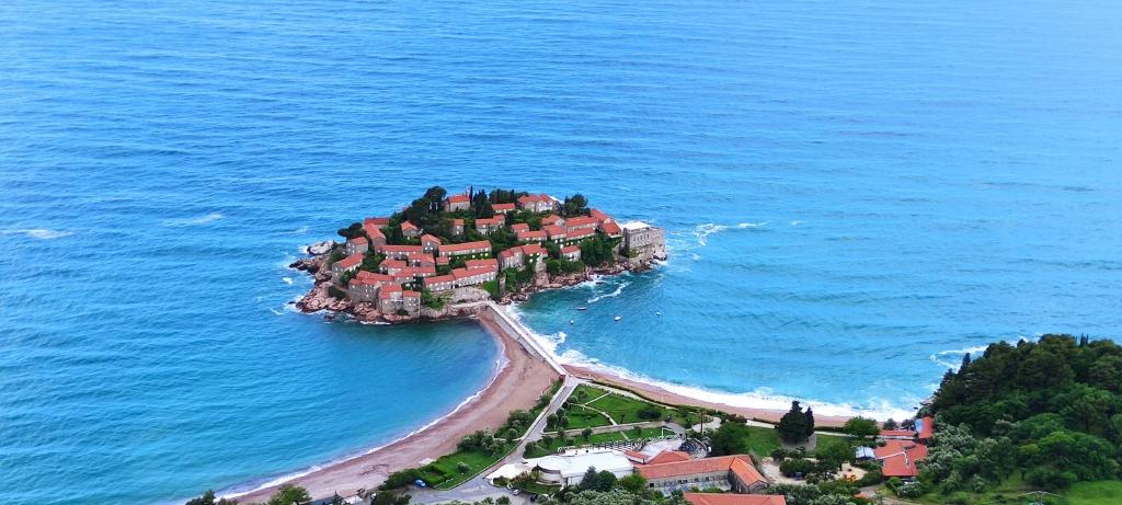 een eiland in de oceaan met huizen erop bij Zoran Apartments in Sveti Stefan