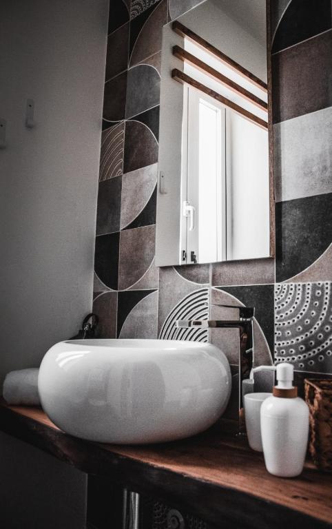 a bathroom with a white sink and a mirror at Laguna Suite B&B in Chioggia