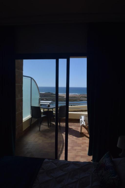 a room with a view of the ocean through a window at Auberge Oualidia Dream in Oualidia