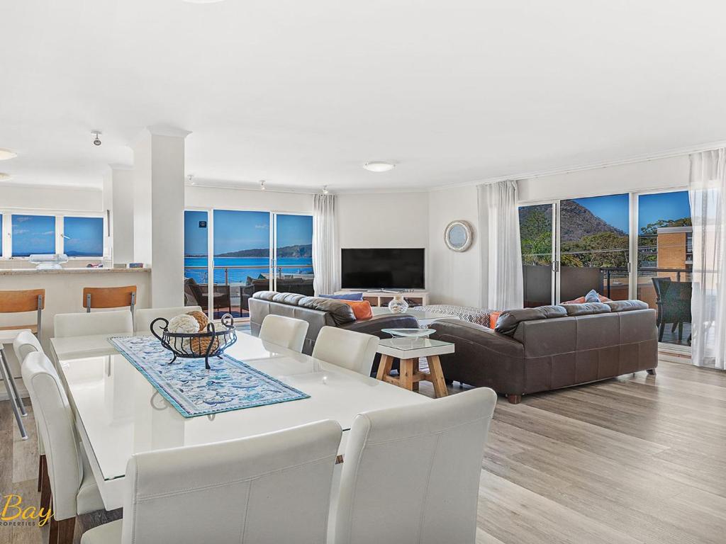 a living room with a table and a couch at Breakwater Apartment 205 in Shoal Bay